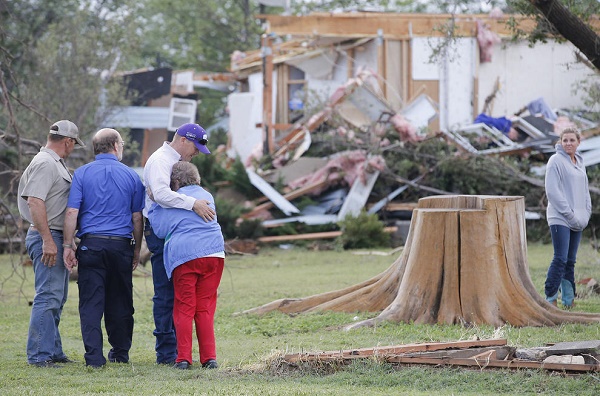 May 6, 2015 - Bentley, Kansas, U.S. - CHARMAINE FORAKER is hugged by her son HARLAN, as she and her other son CRAIG FORACKER, second from left, arrive at the scene of the family farmstead that was destroyed by a tornado. The original farmhouse that Charmaine grew up in was destroyed, along with a newer home that Craig and his family lived in. (Credit Image: © Travis Heying/TNS/ZUMA Wire)